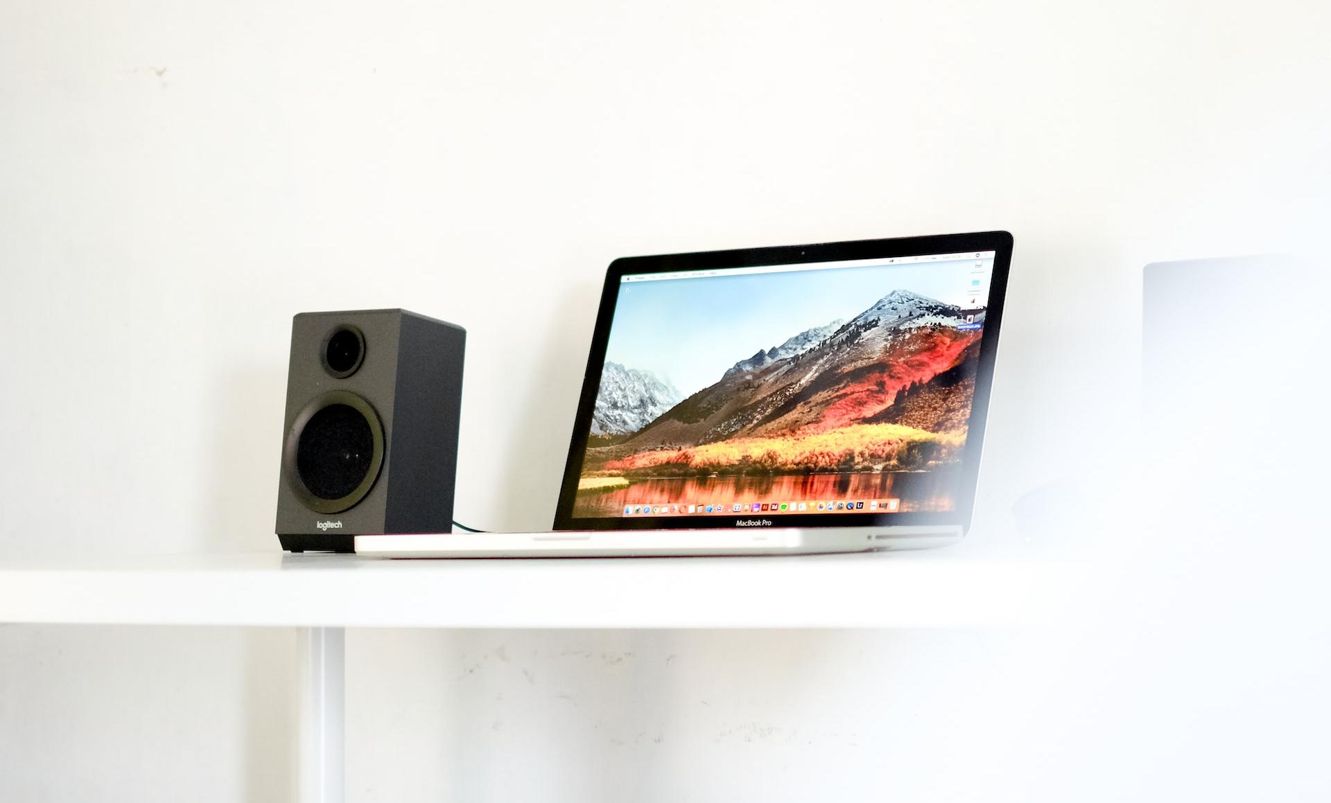 laptop beside speaker